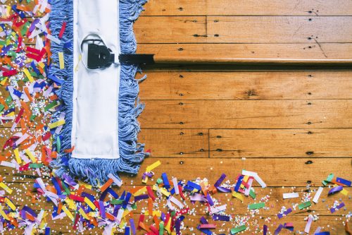 A pushbroom cleaning up confetti after a party or celebration.